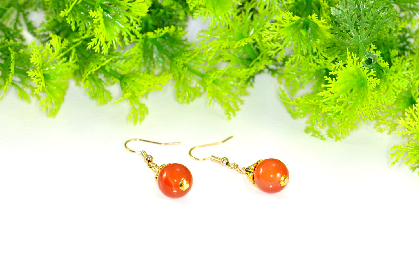 Close up of 12mm Natural Carnelian Crystal Drop Earrings.