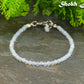 3mm Clear White Opalite Bracelet on a stone surface.