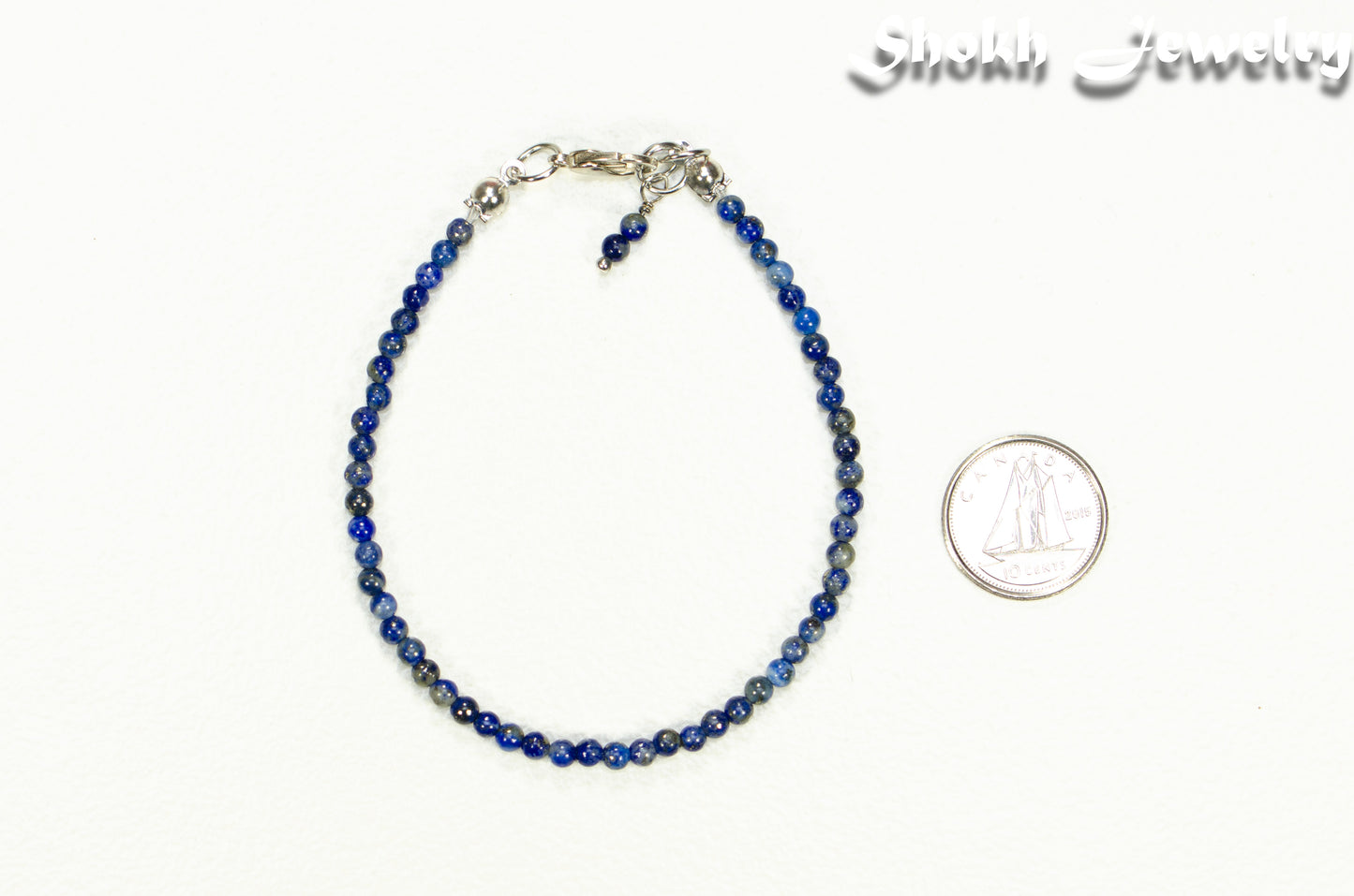 3mm Lapis Lazuli bracelet beside a dime.