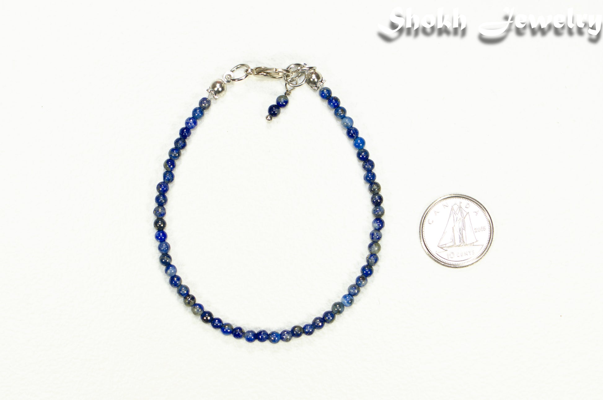 3mm Lapis Lazuli bracelet beside a dime.