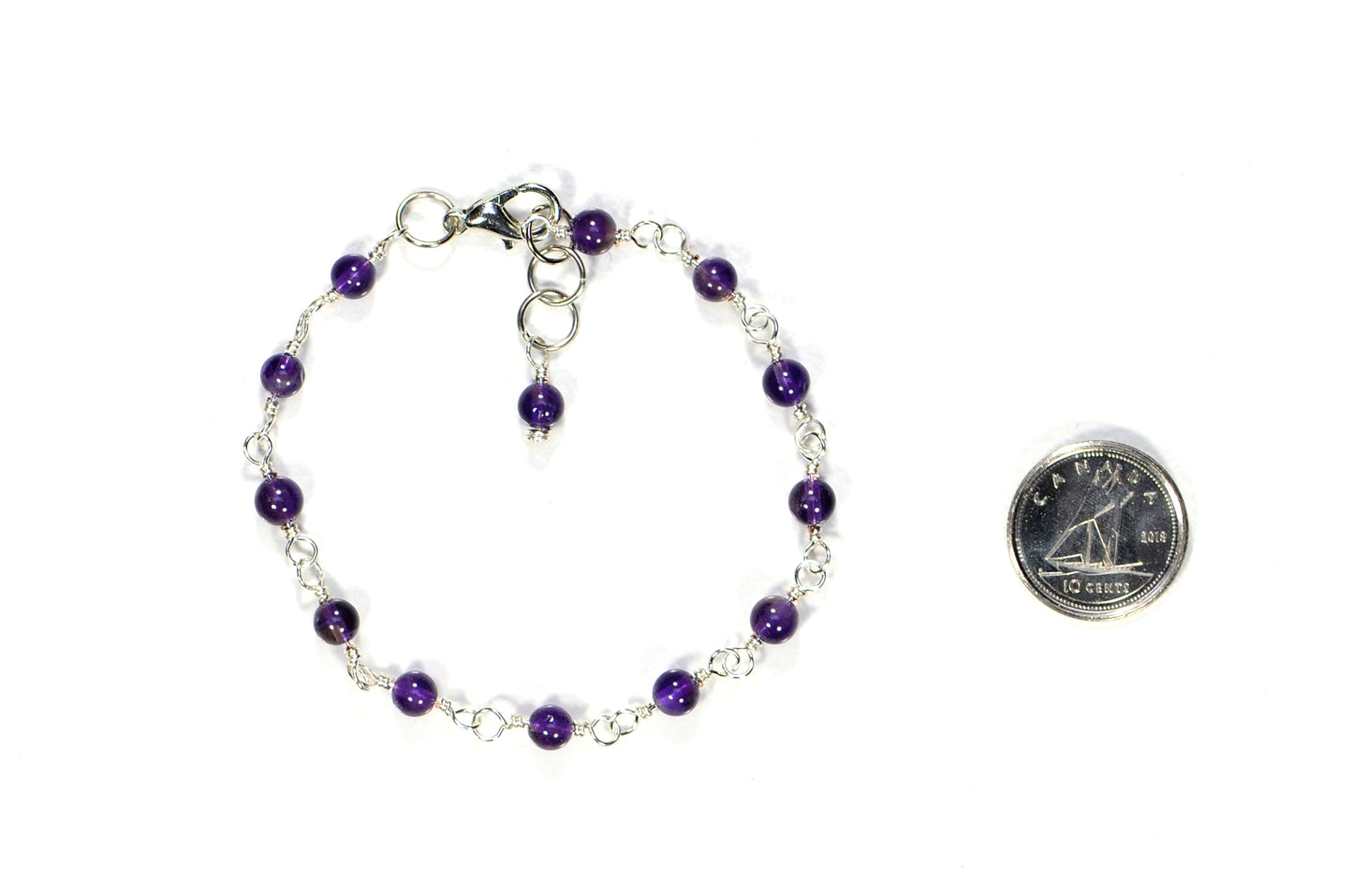 4mm Amethyst Link Anklet beside a dime.