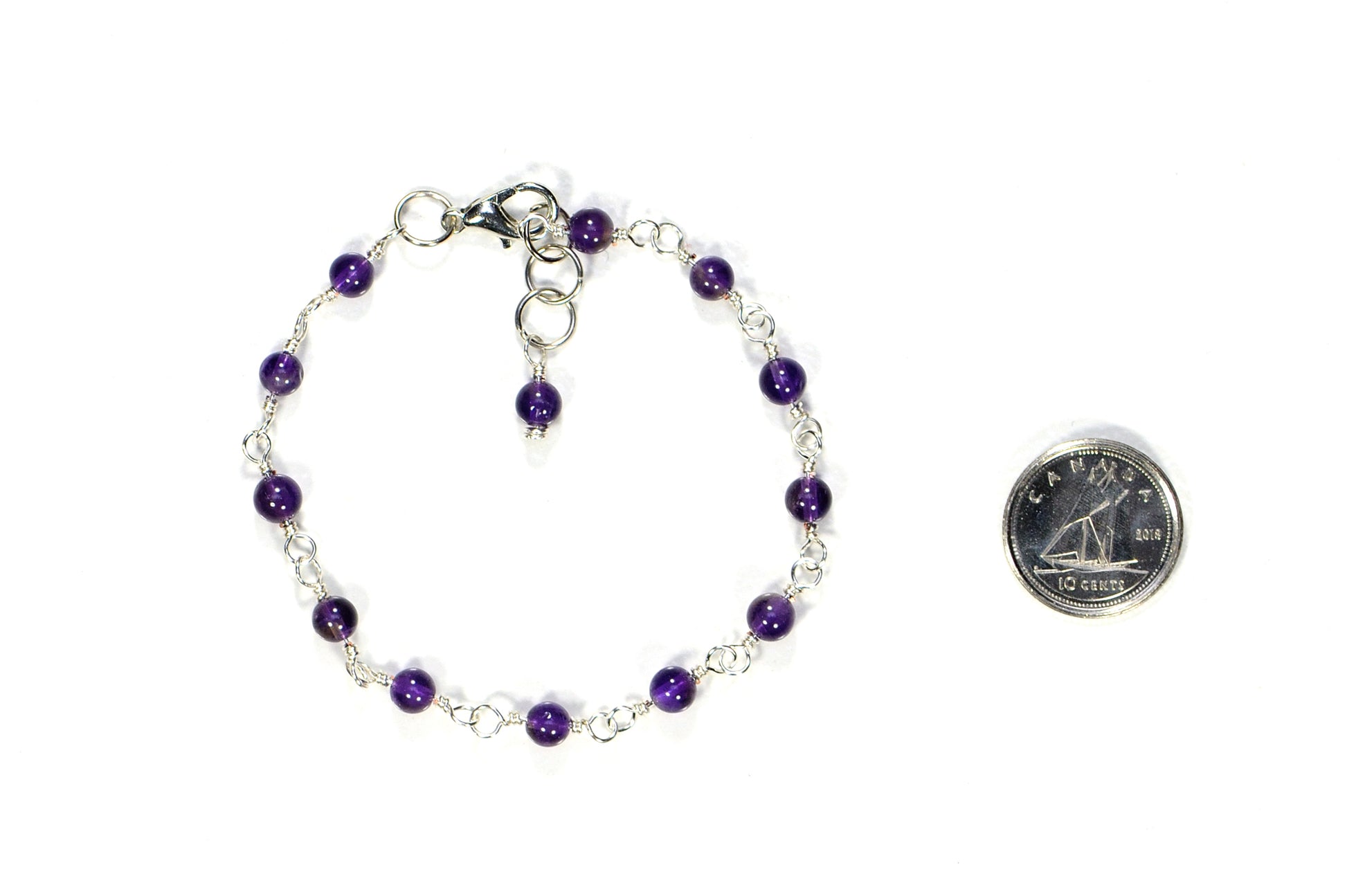 4mm Amethyst Link Anklet beside a dime.