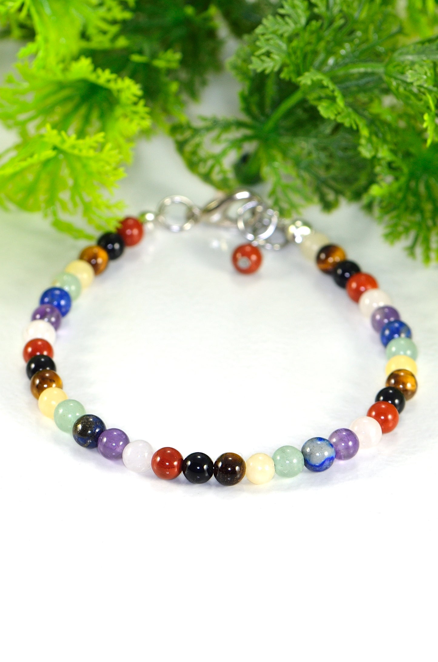 4mm Chakra Gemstone Anklet made with 4mm natural rose quartz, lapis lazuli, amethyst, green aventurine, calcite, tiger's eye, black obsidian and red jasper crystal beads strung on sturdy beading wire, finished with a lobster clasp.