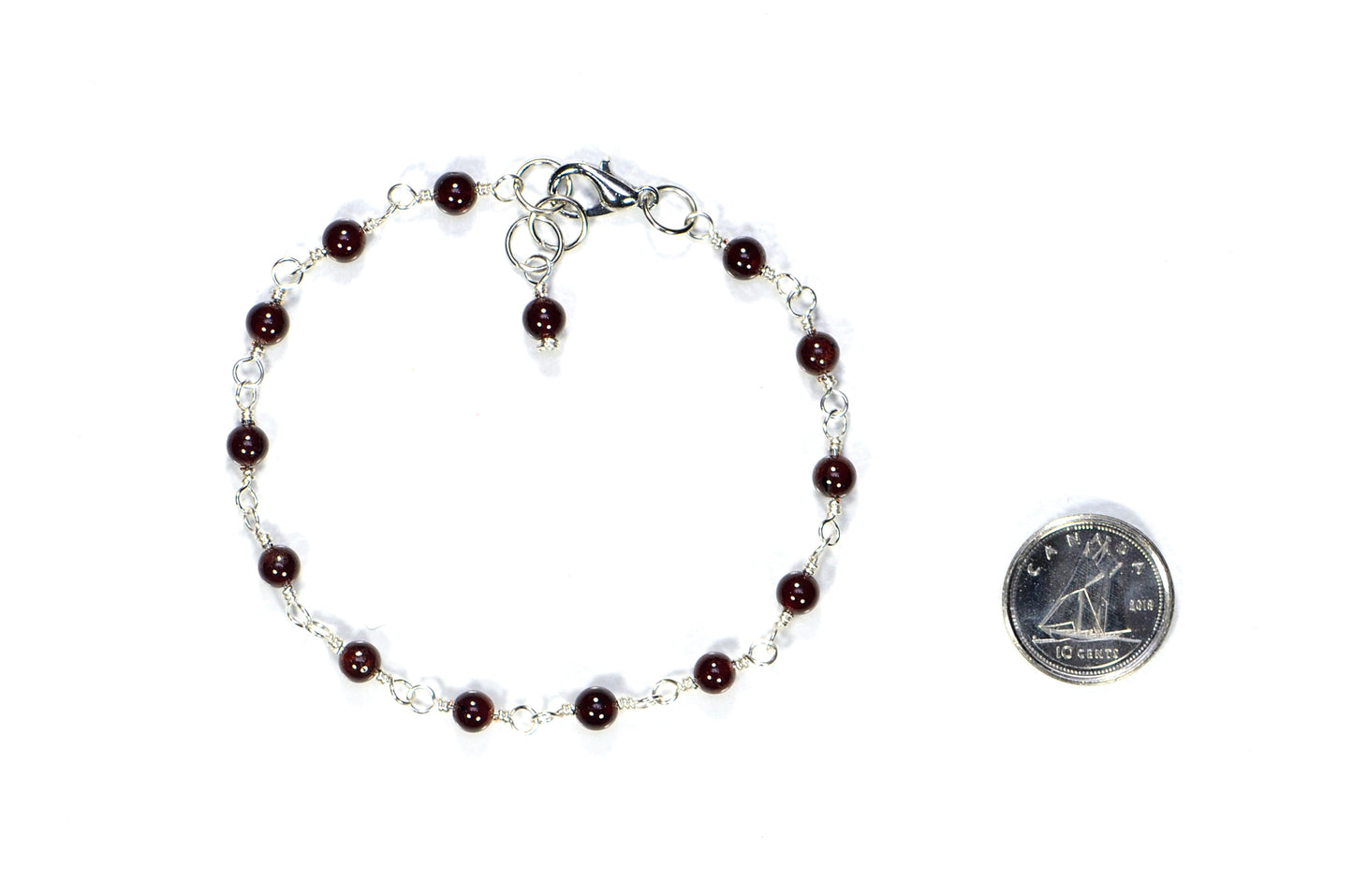 4mm Garnet Link Anklet beside a dime.