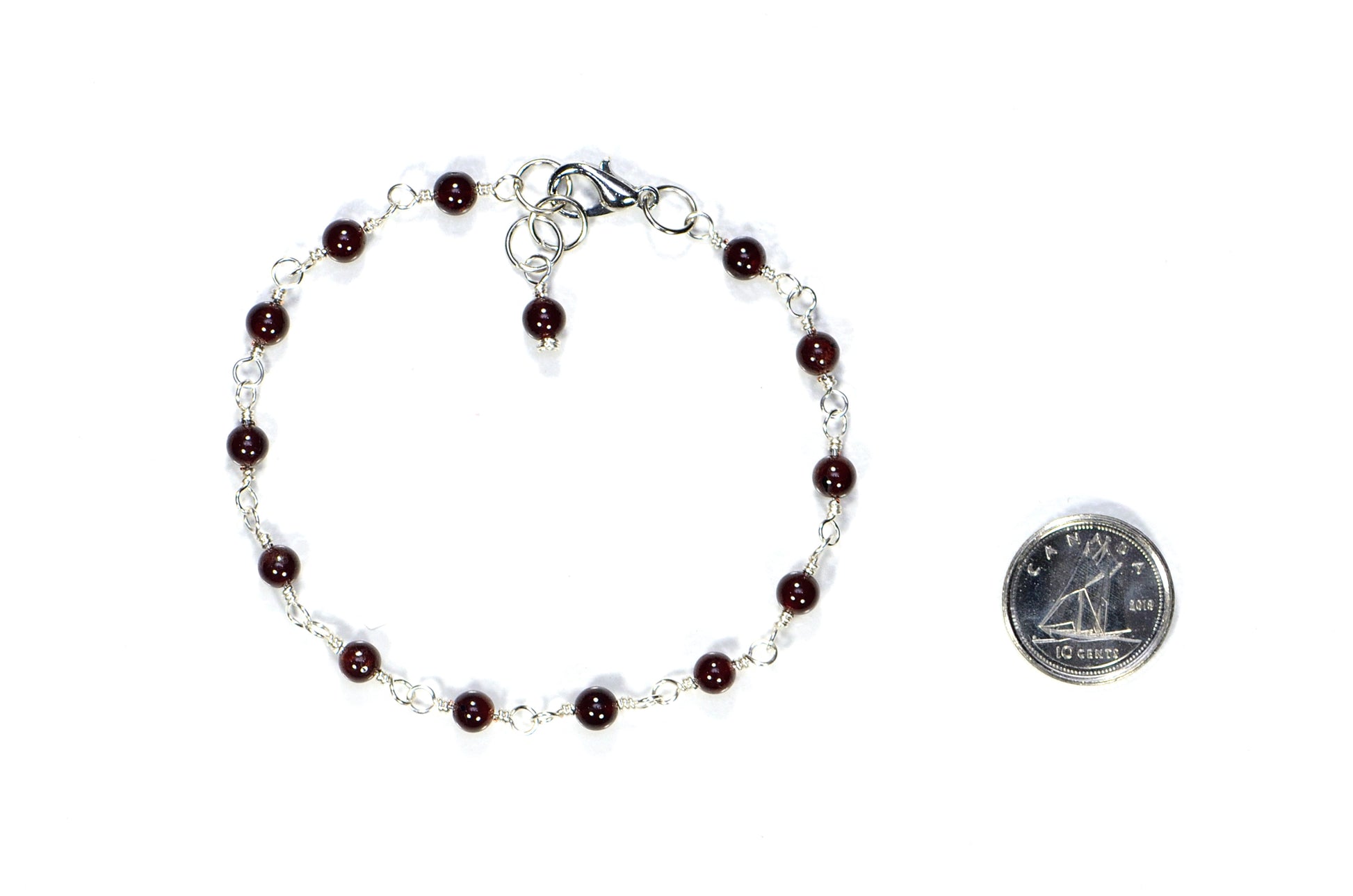 4mm Garnet Link Anklet beside a dime.