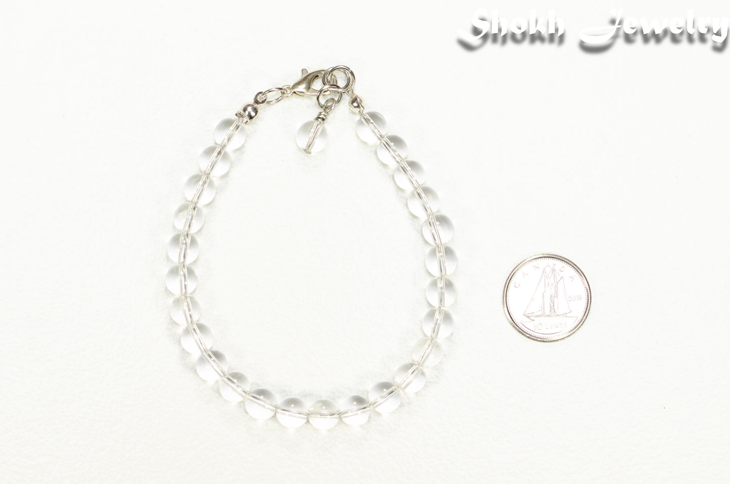 6mm Clear Quartz Beaded Anklet beside a dime.