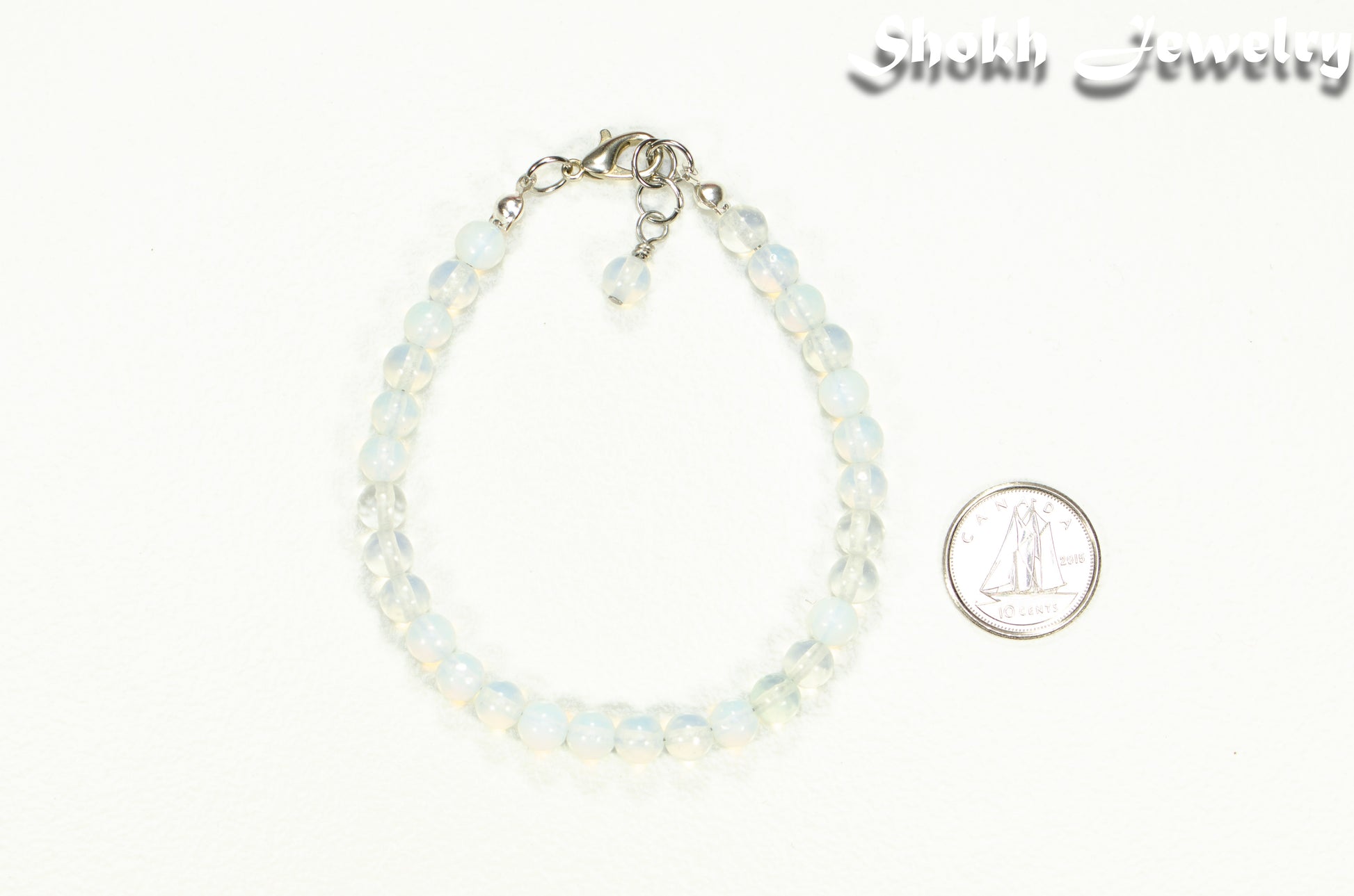 6mm Clear White Opalite Beaded Anklet beside a dime.