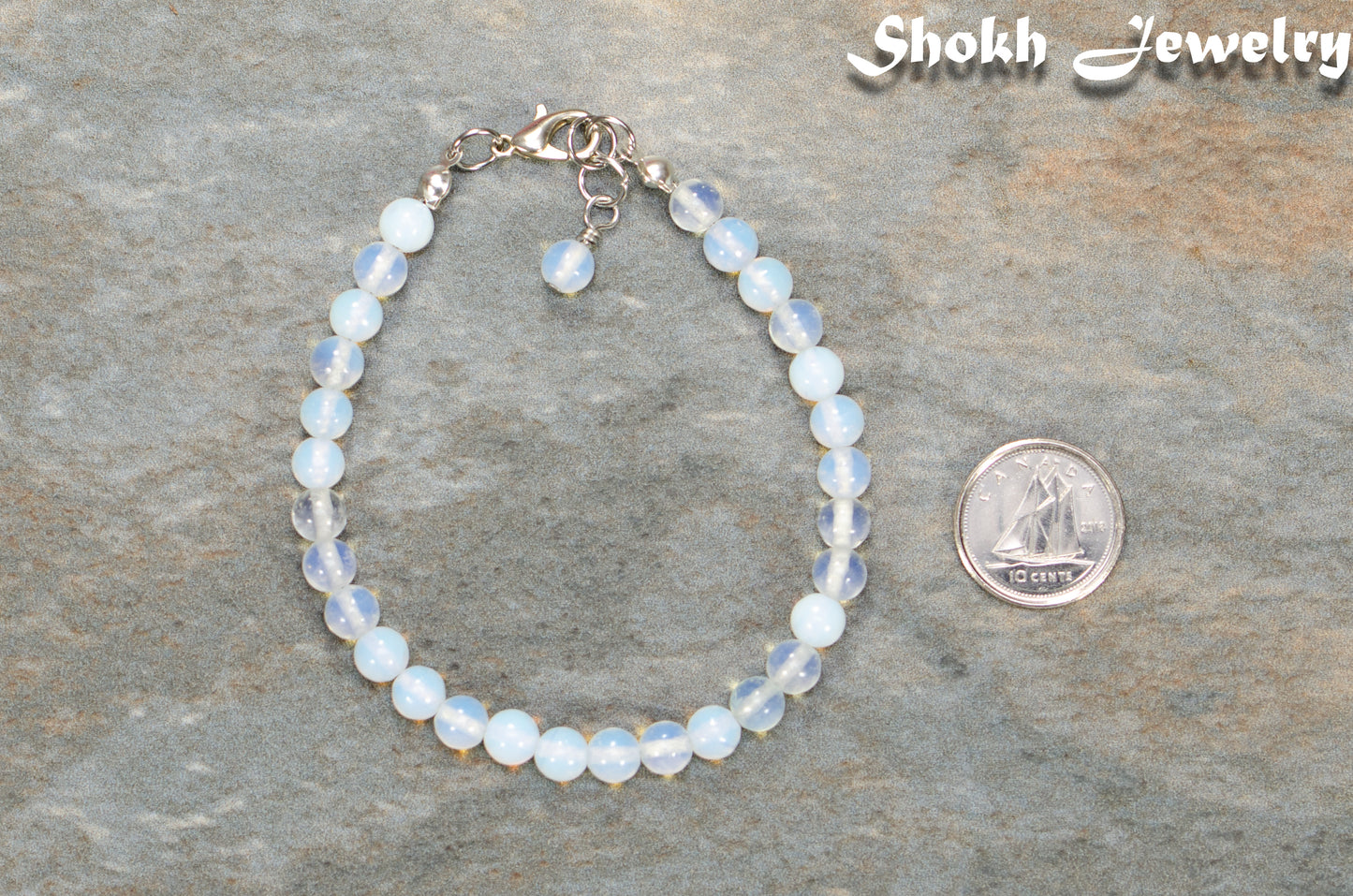 6mm Clear White Opalite Beaded Bracelet beside a dime.