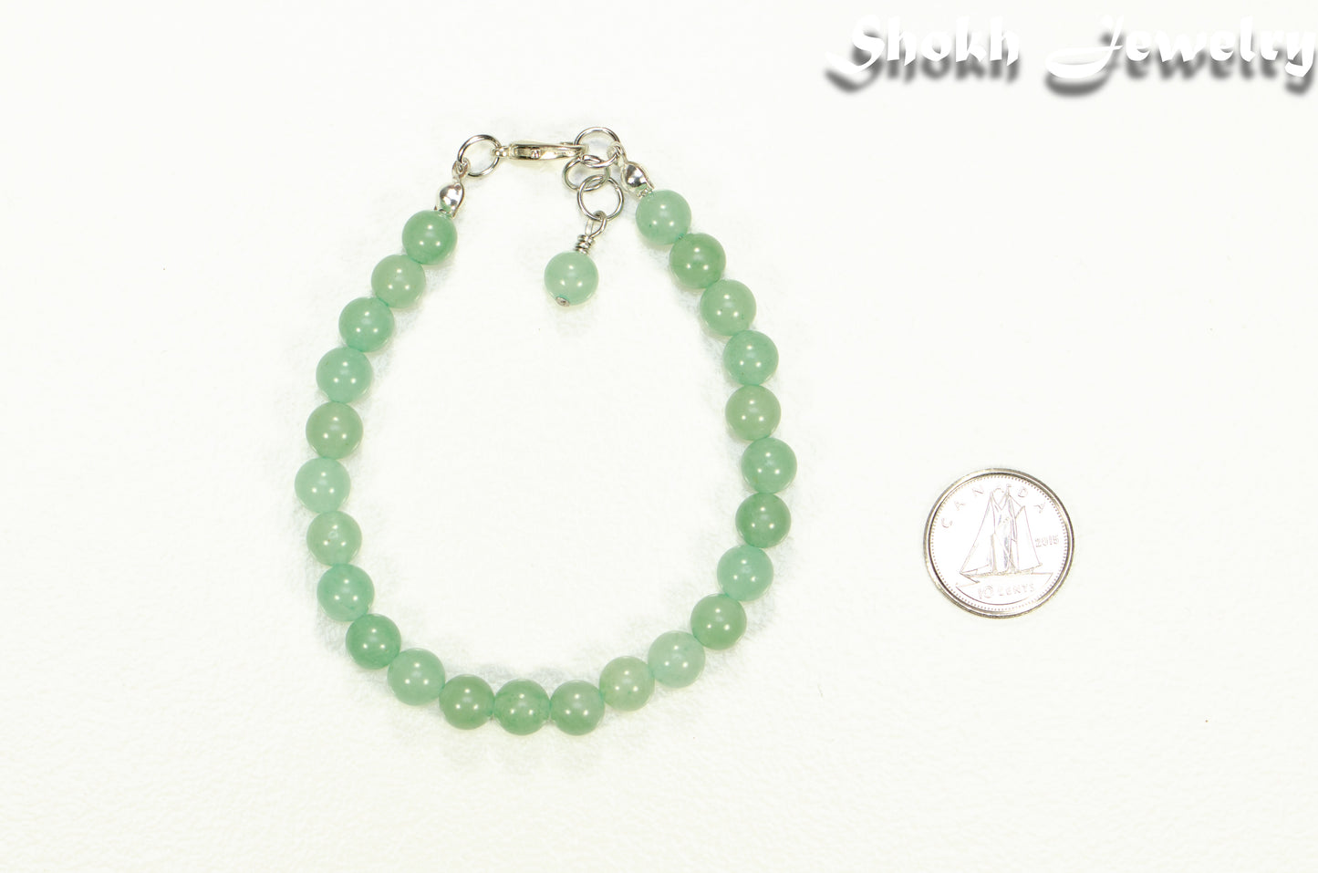 6mm Green Aventurine Beaded Bracelet beside a dime.