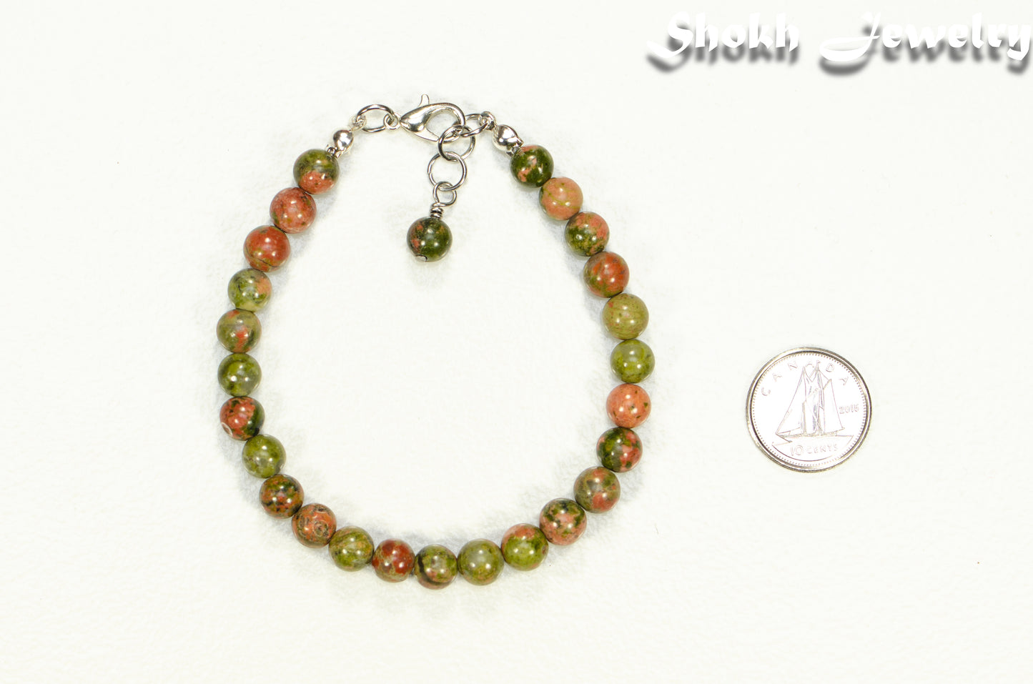 6mm Unakite Jasper Beaded Bracelet beside a dime.