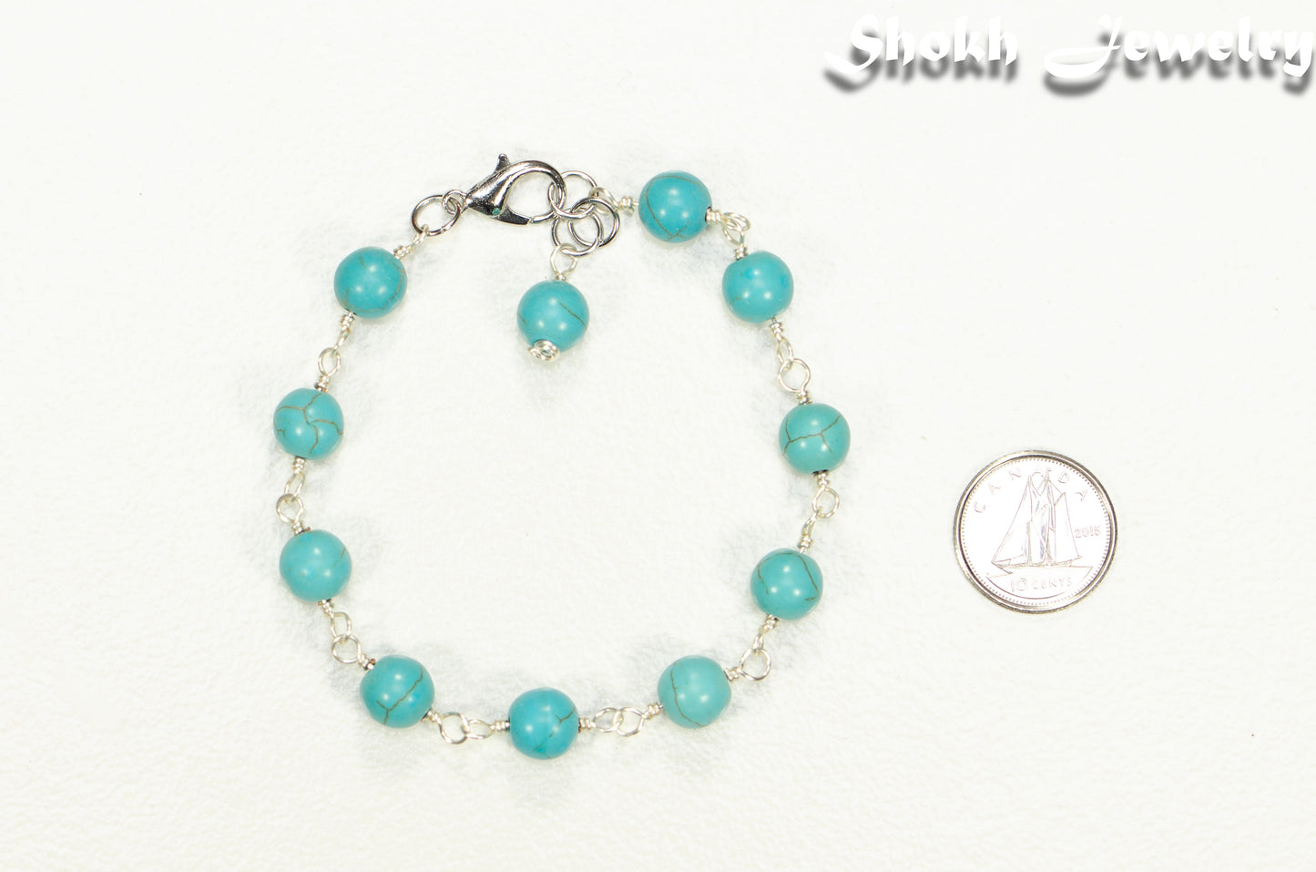 8mm Turquoise Howlite Link Anklet beside a dime.