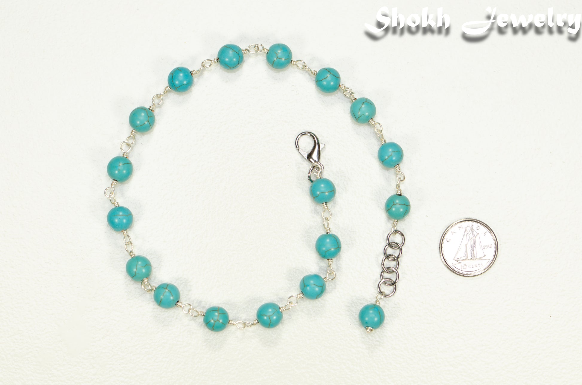 8mm Turquoise Howlite Link Choker Necklace beside a dime.