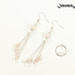 Cascading Rose Quartz Crystal Drop Earrings beside a dime.

