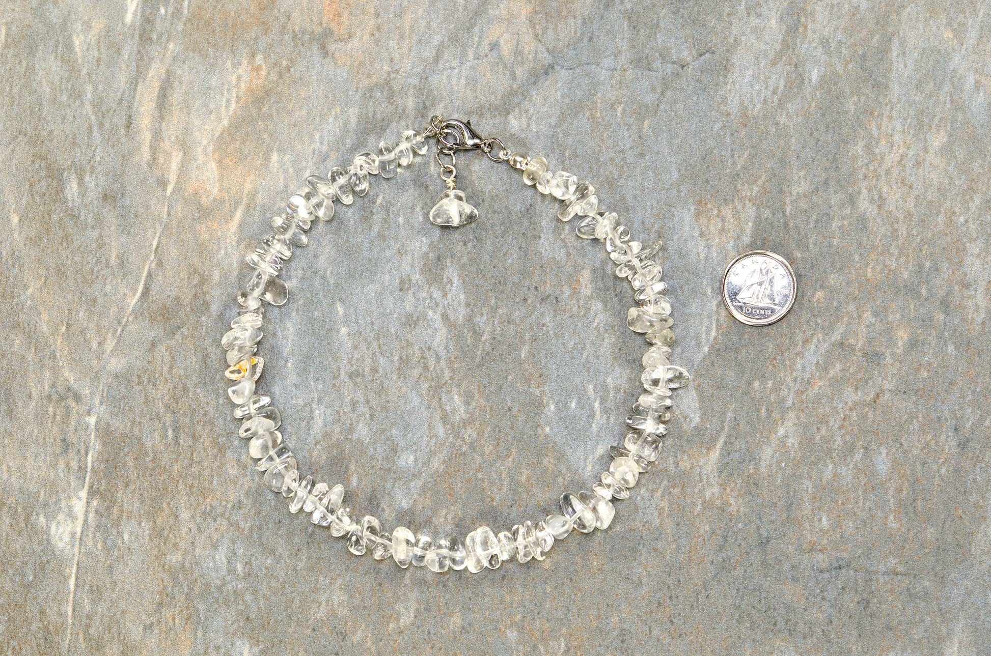 Clear Quartz Crystal Chip Choker Necklace beside a dime.