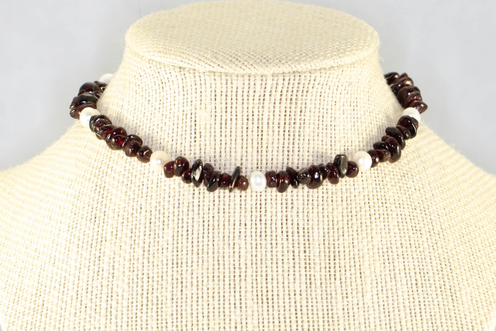 Freshwater Pearls and Garnet Crystal Chip Choker Necklace displayed on a bust.