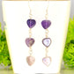 Natural Amethyst Heart Dangle Earrings displayed on a tea cup.