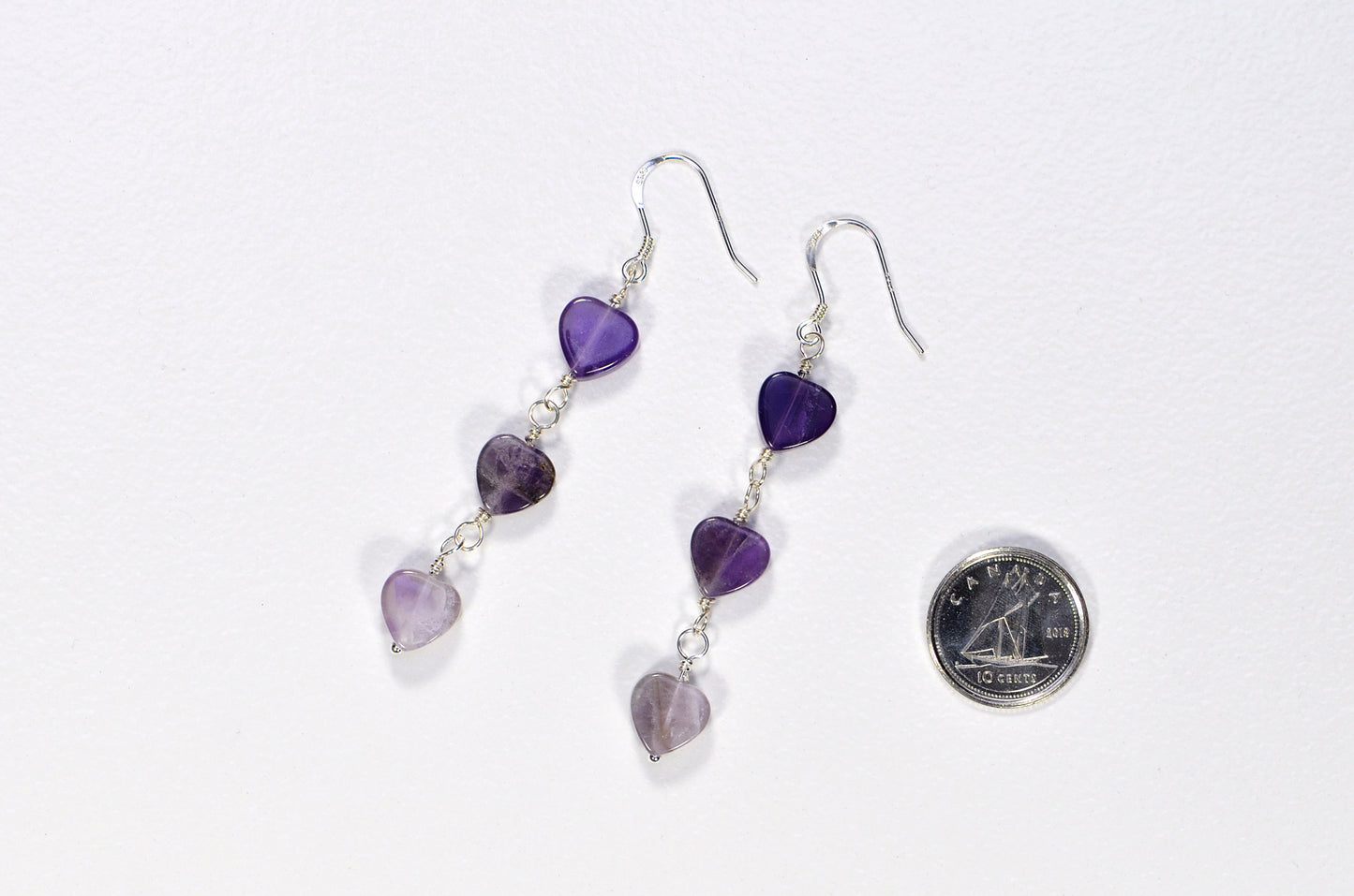 Natural Amethyst Heart Dangle Earrings beside a dime.