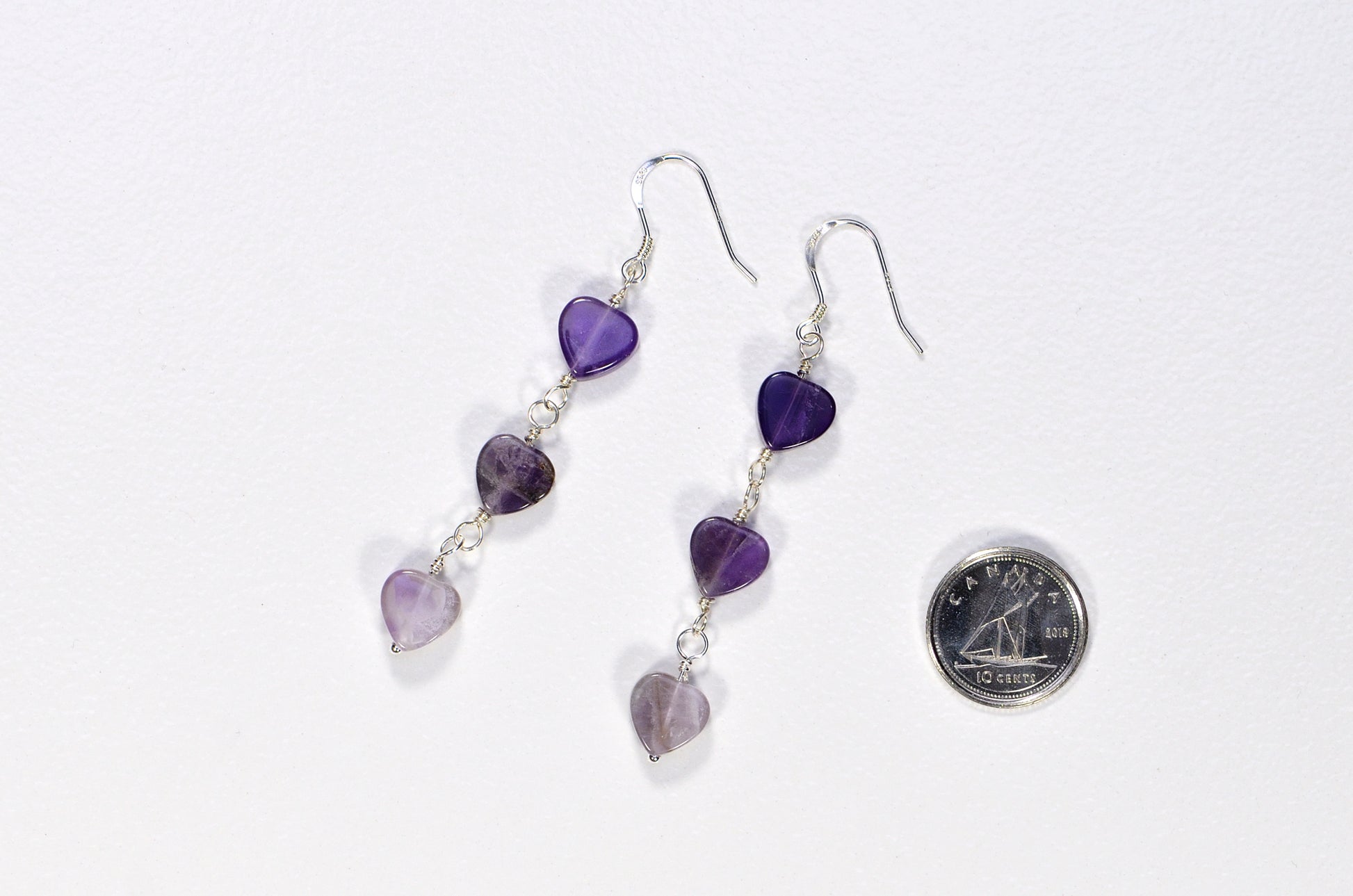 Natural Amethyst Heart Dangle Earrings beside a dime.