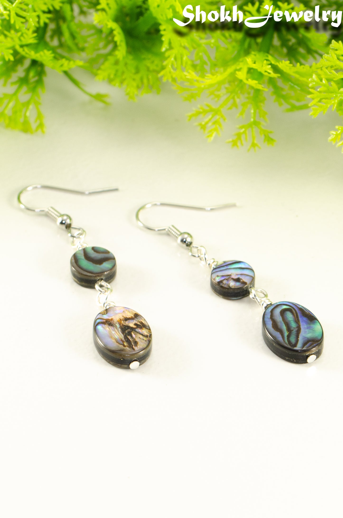 Close up of Elegant Long Oval Abalone Shell Earrings.
