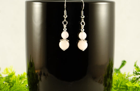 Small Rose Quartz Earrings displayed on a  coffee mug.