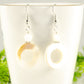 Close up of White Doughnut Seashell Earrings.