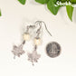 White Howlite and Tibetan Silver Maple Leaf Dangle Earrings beside a dime.