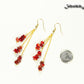Long Gold Plated Chain and Red Dyed Bamboo Coral Chip Earrings beside a dime.