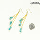 Long Gold Plated Chain and Turquoise Crystal Chip Earrings beside a dime.