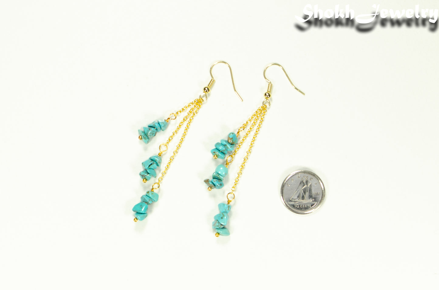 Long Gold Plated Chain and Turquoise Crystal Chip Earrings beside a dime.