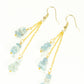 Top view of Long Gold Plated Chain and Aquamarine Crystal Chip Earrings.