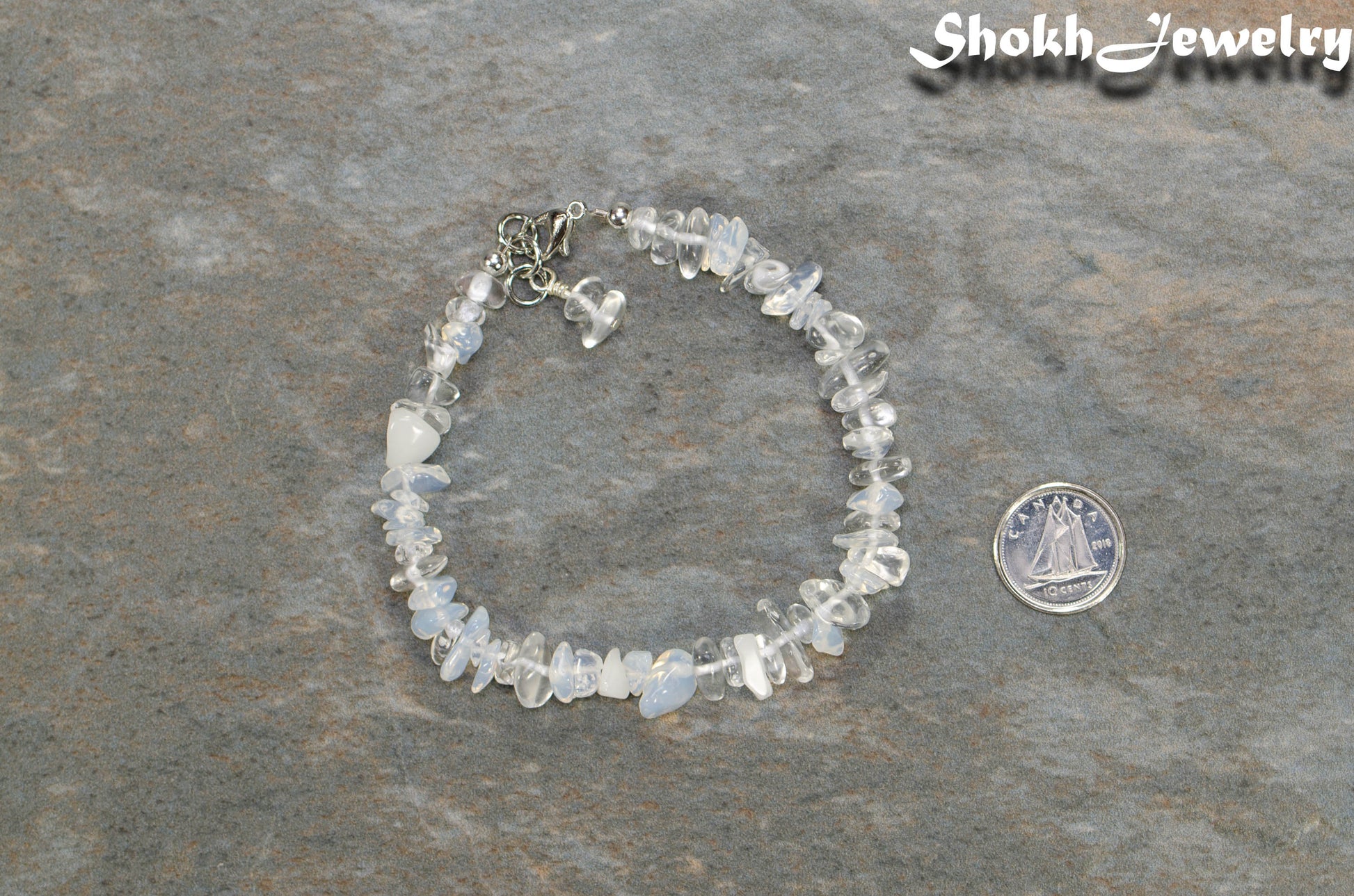Natural White Opal Crystal Chip Bracelet  beside a dime.