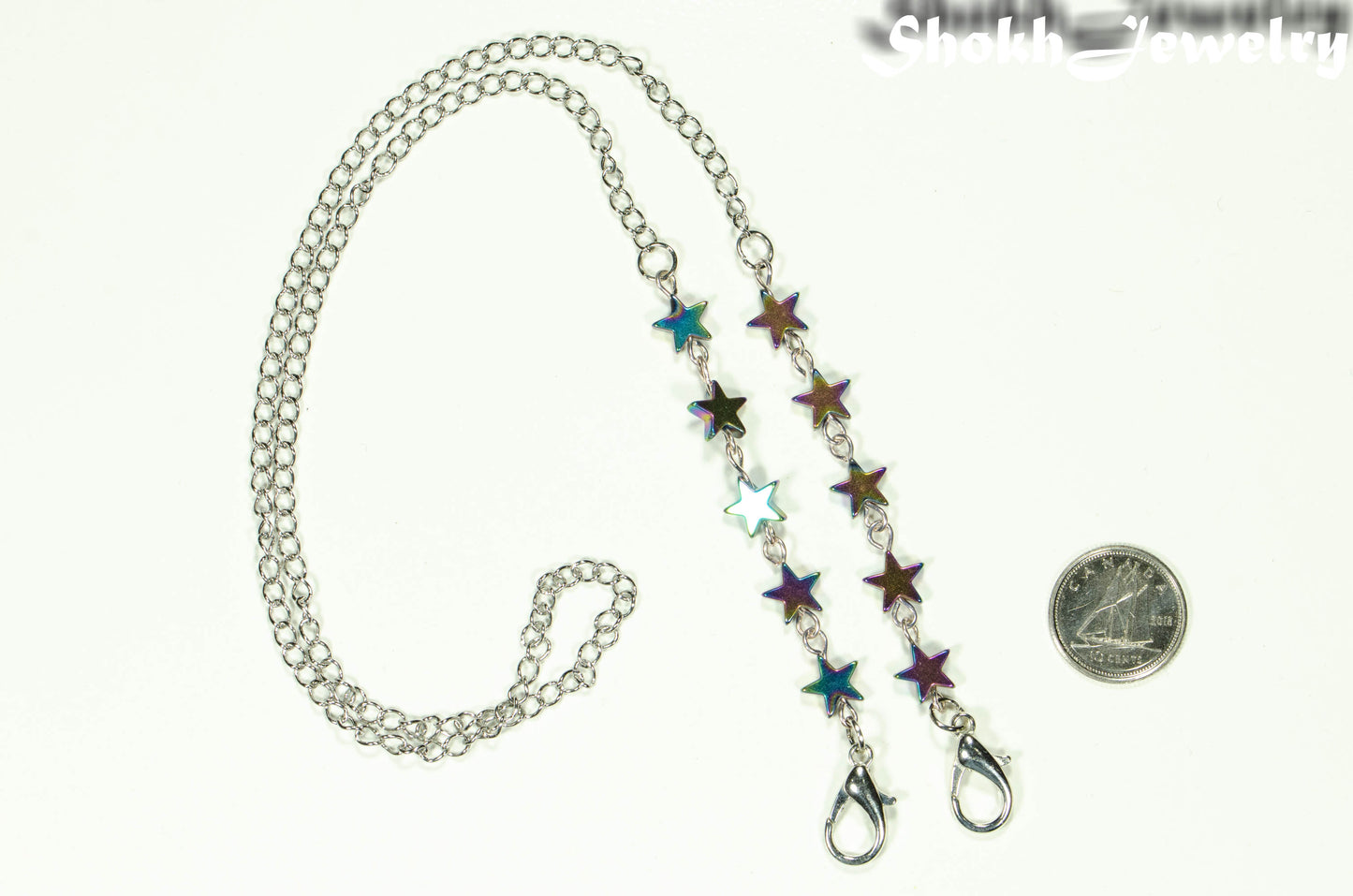 Rainbow Hematite Star Eyeglass Chain beside a dime.