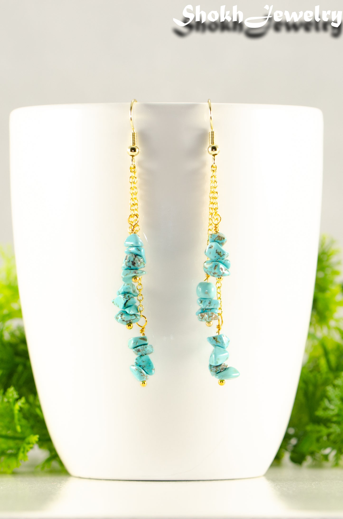 Close up of Long Gold Plated Chain and Turquoise Crystal Chip Earrings.