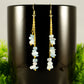 Close up of Long Gold Plated Chain and Aquamarine Crystal Chip Earrings.