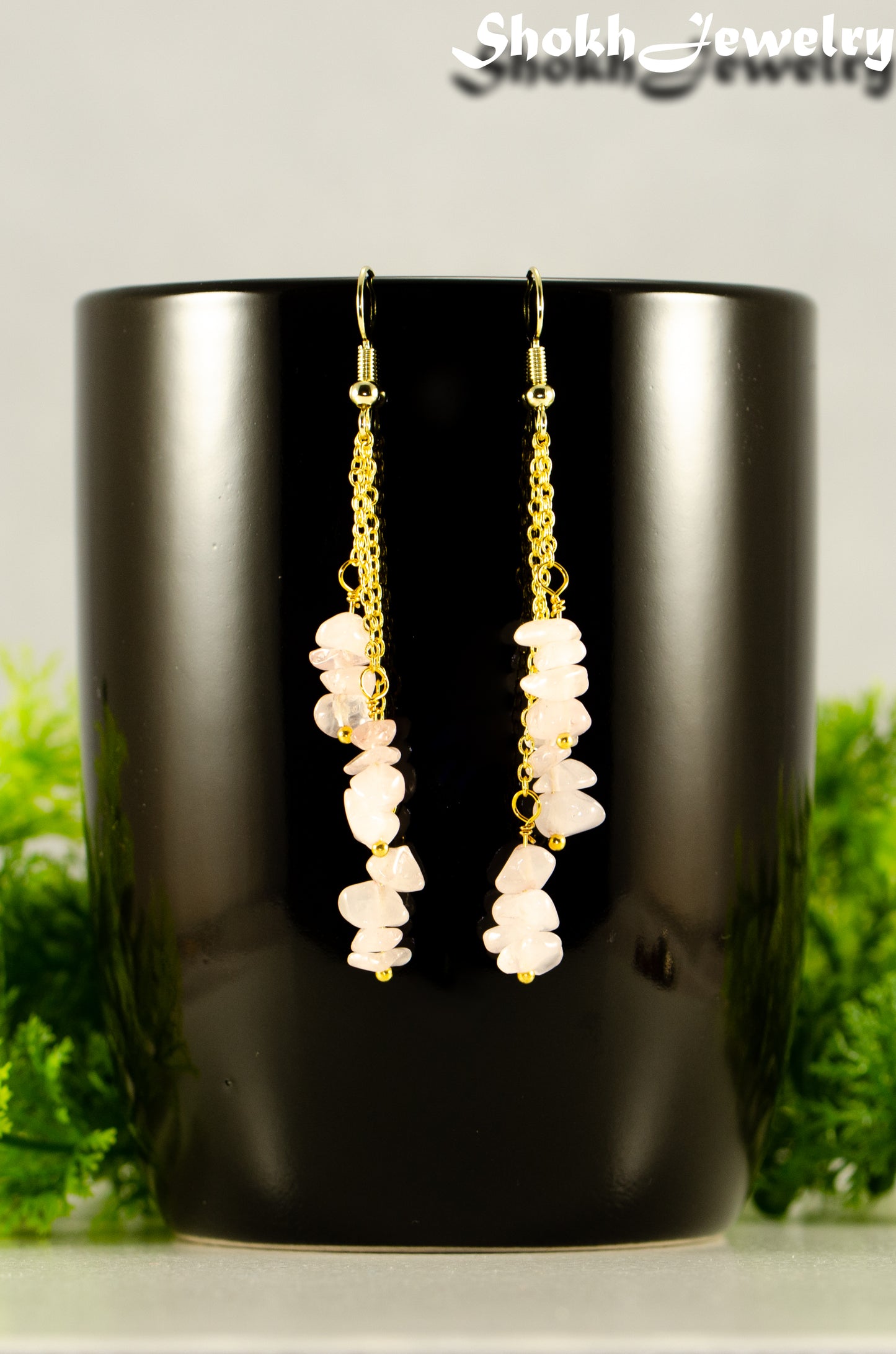 Close up of Long Gold Plated Chain and Rose Quartz Crystal Chip Earrings.
