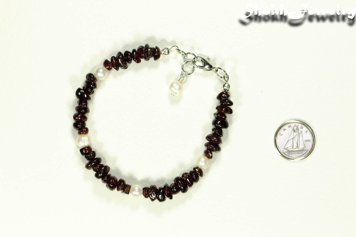 Natural Garnet Crystal Chip and Pearls Bracelet beside a dime.
