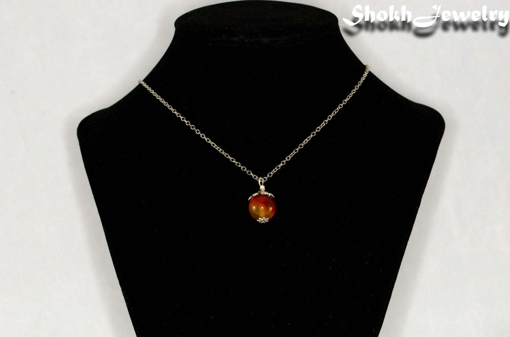 12mm Carnelian Pendant Necklace displayed on a bust.