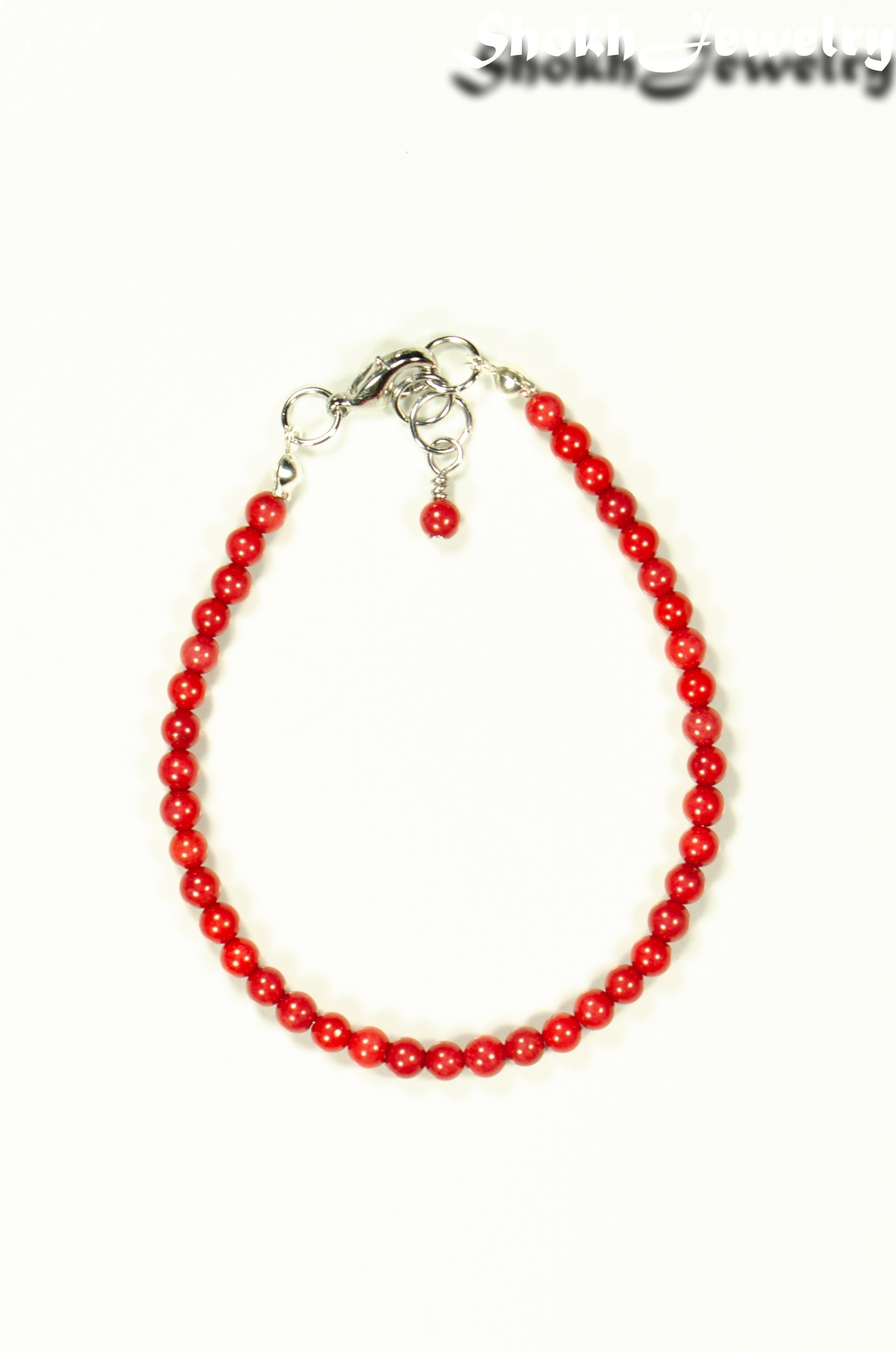 Top view of 4mm Natural Red Coral Bracelet with Clasp.