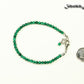 3mm Natural Malachite Bracelet with Clasp beside a dime.