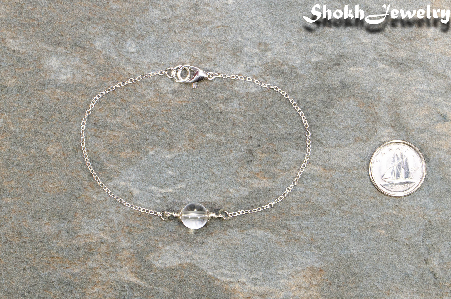 Minimal Clear Quartz Bracelet beside a dime.