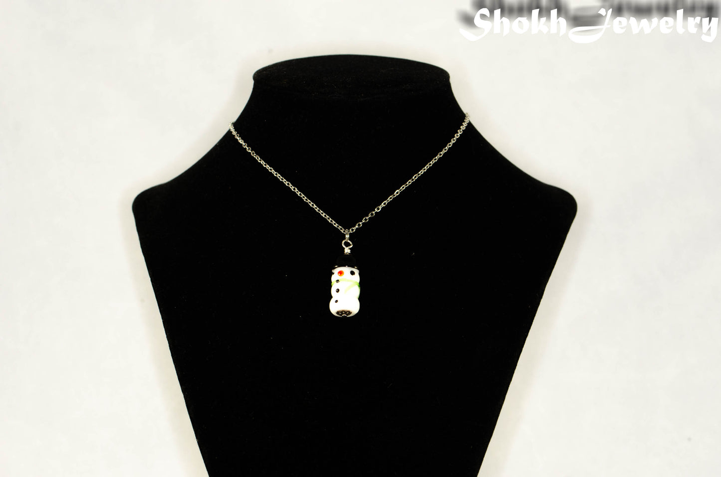 Glass Bead Snowman Pendant Necklace displayed on a bust.