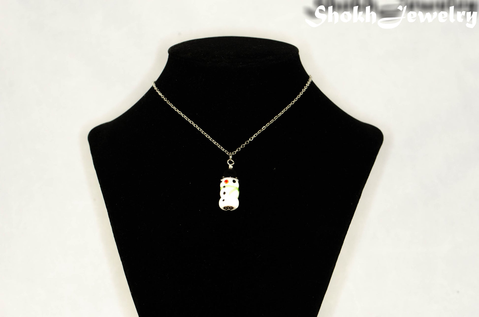 Glass Bead Snowman Pendant Necklace displayed on a bust.
