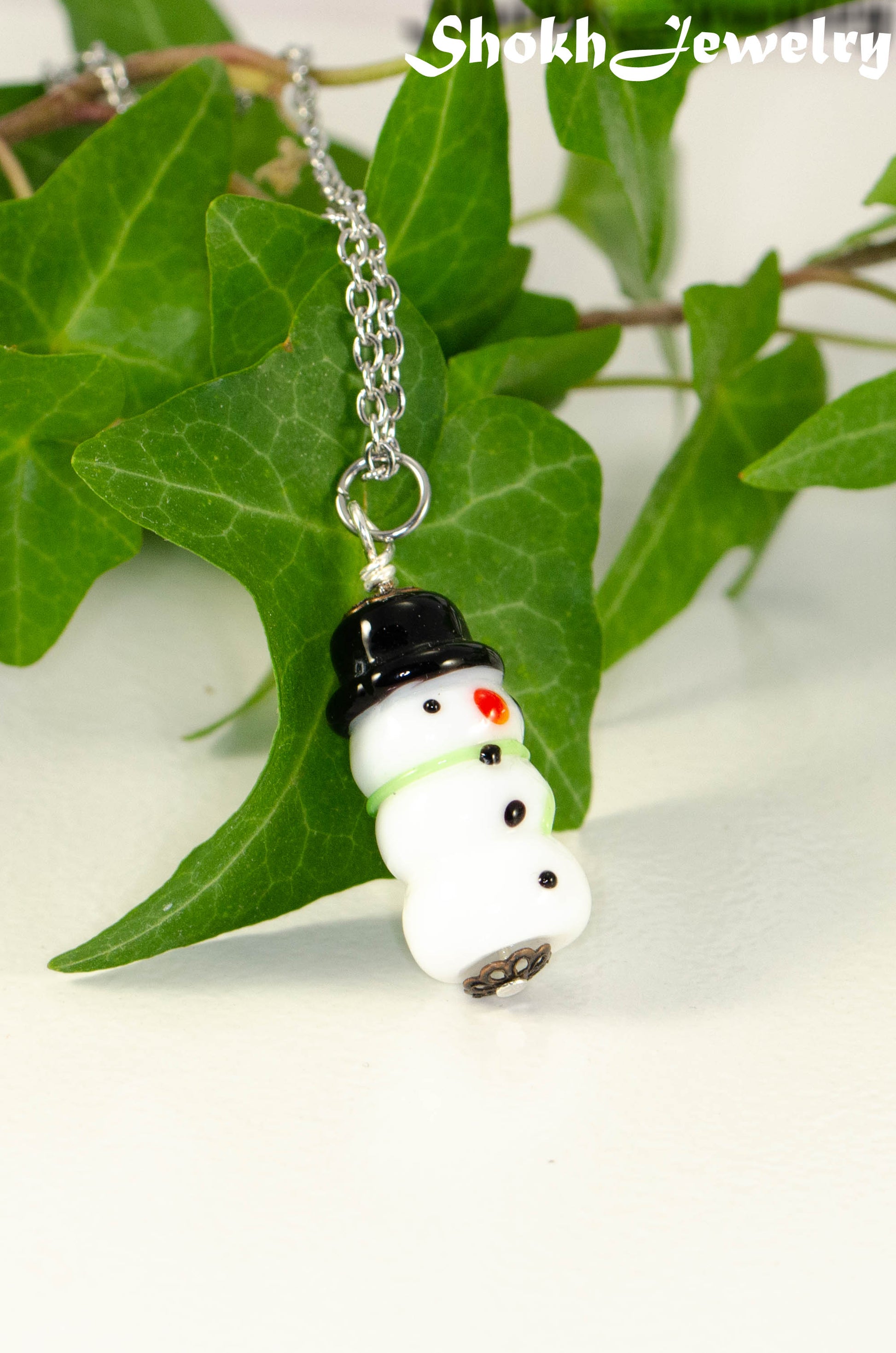 Close up of Glass Bead Snowman Pendant.