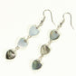 Top view of Long Grey Seashell Hearts Earrings.