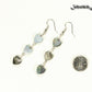 Long Grey Seashell Hearts Earrings beside a dime.