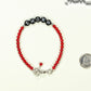 Copy of Personalized Natural Red Coral Name Bracelet with Clasp beside a dime.