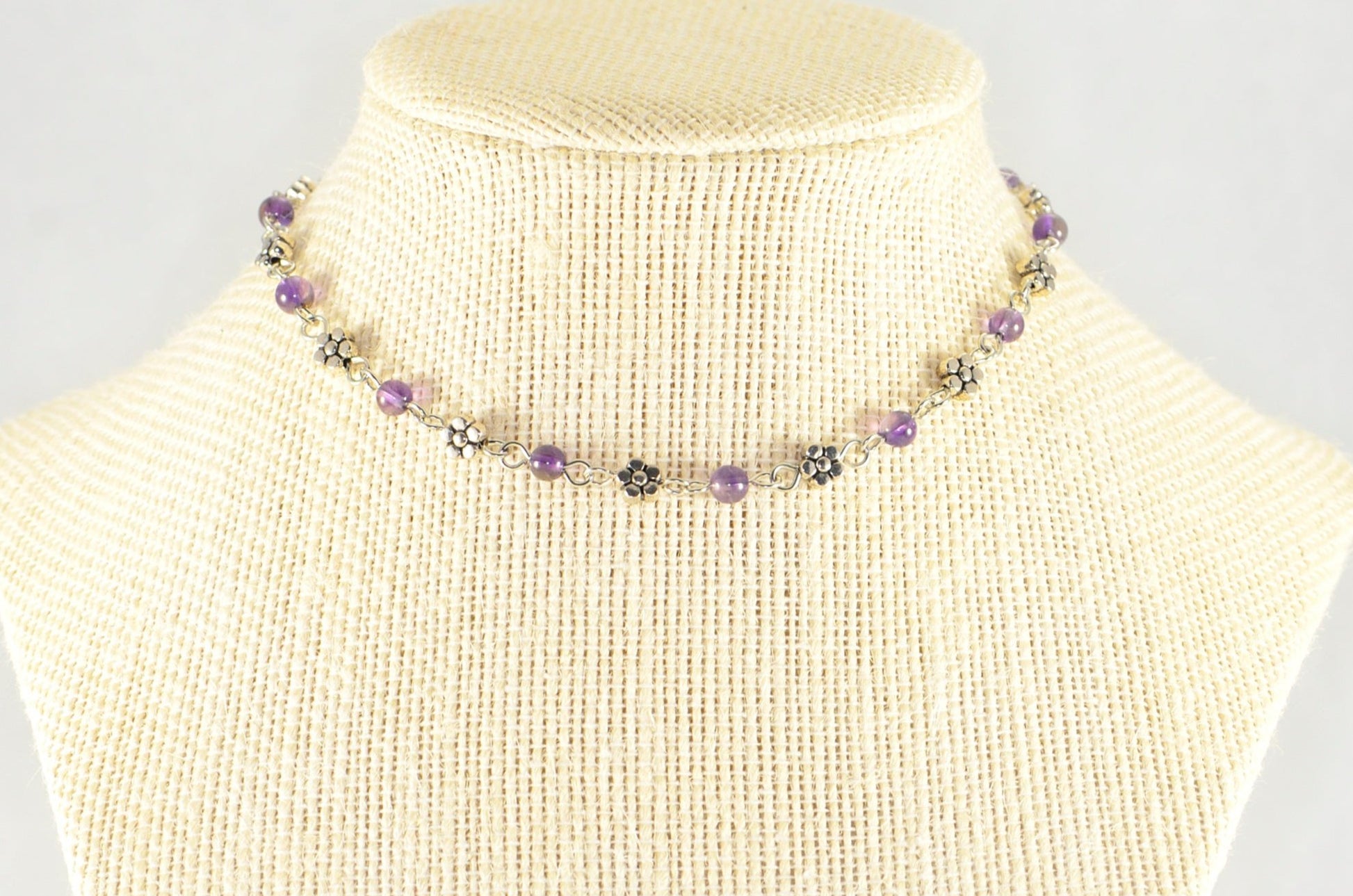 Tibetan Silver Flower and Amethyst Choker Necklace displayed on a bust.
