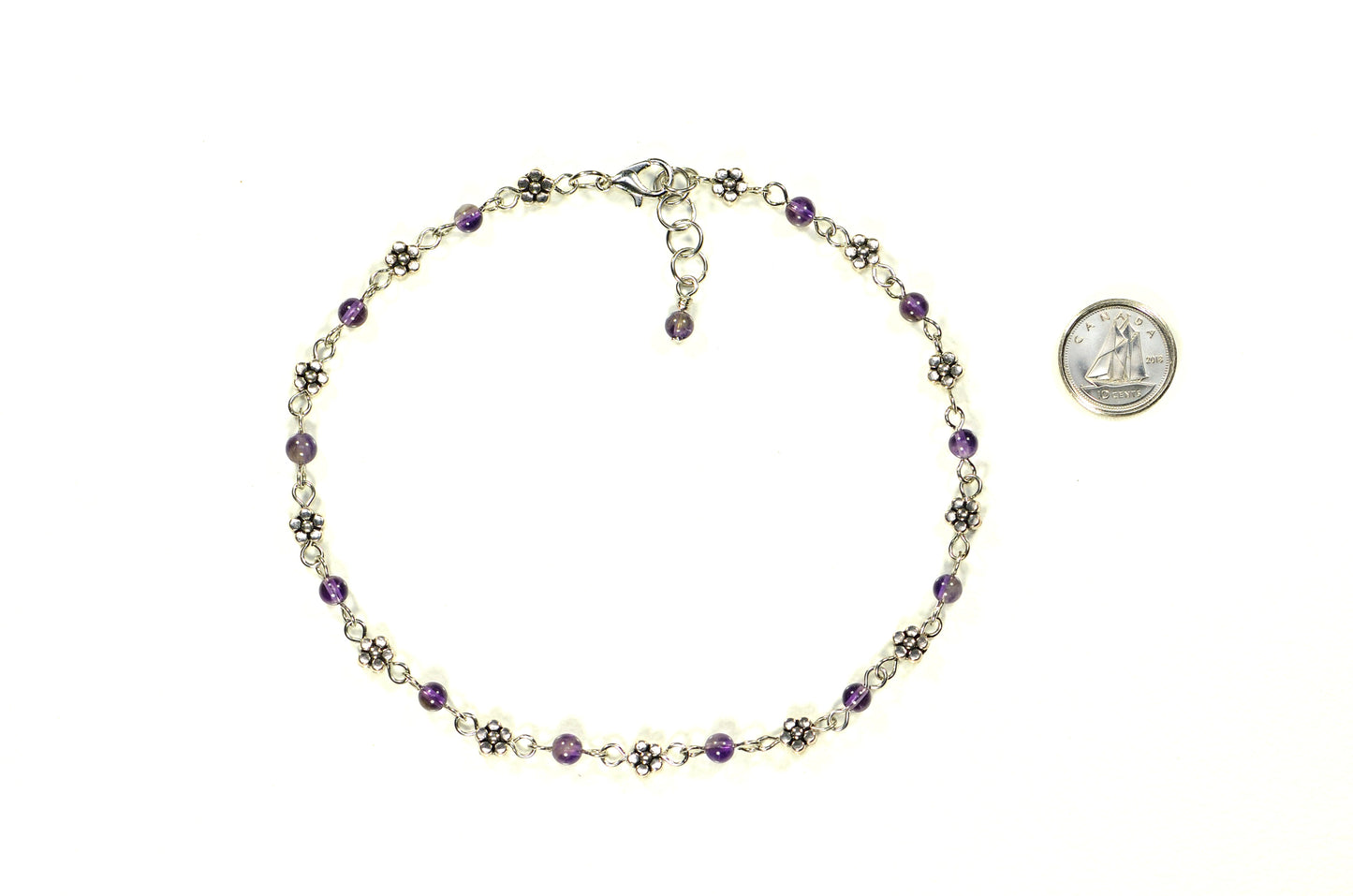 Tibetan Silver Flower and Amethyst Choker Necklace beside a dime.
