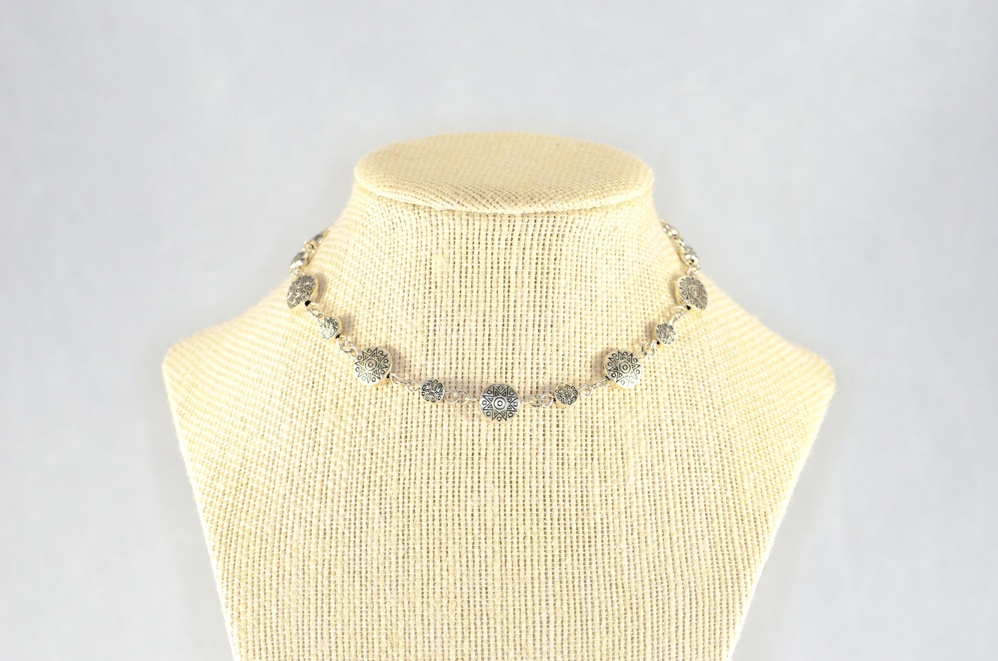 Tibetan Silver Star Sun and Moon Choker Necklace displayed on a bust.