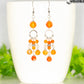 Statement Carnelian Crystal Chandelier Earrings displayed on a coffee mug.
